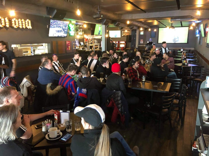 Sports fans fill 817 Sports Bar and Grill in Toronto.