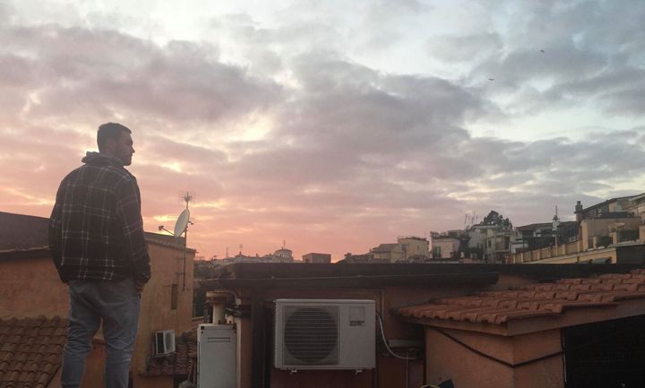 Canadian Thomas Gough watches the sun set from his terrace in Rome.