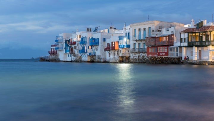 MYKONOS, GREECE - NOVEMBER 16: Mikri Venetia or Little Venice illuminated at night at Mykonos Town on November 16, 2019 in Mykonos, Greece. (Photo by Athanasios Gioumpasis/Getty Images)