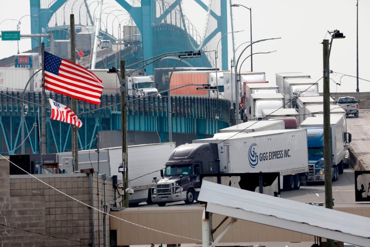 Vehicles cross at the US Customs booth at the Ambassador Bridge that connects Windsor, Canada to Detroit, Mich. on March 18, 2020 in Detroit, Mich.