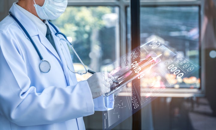 Doctor holding tablet with futuristic hud screen tablet. Covid-19, Bacteria, virus, microbe. Medical concept of the future.