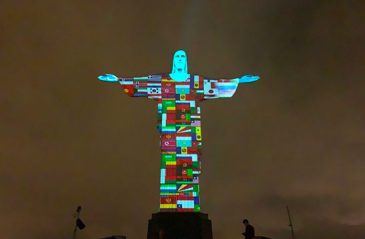 Flags of the countries affected by the spread of the new coronavirus are projected on the Christ the Redeemer statue in Rio d