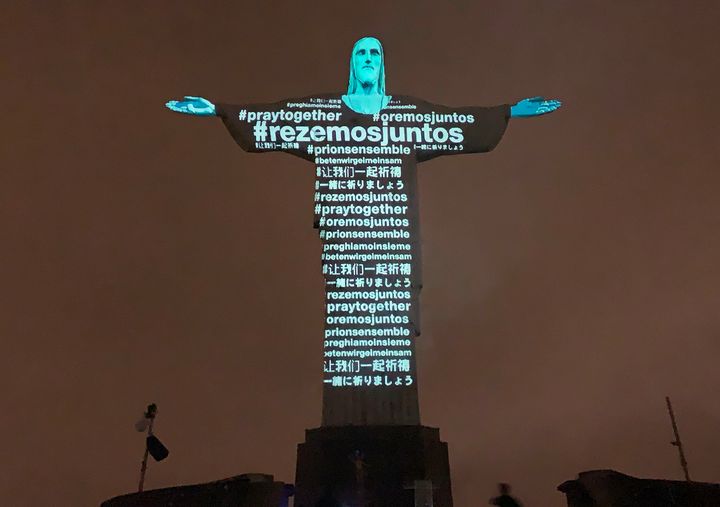 Messages calling for prayer are projected on the Christ the Redeemer statue in Rio on March 18, 2020.
