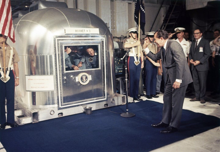 Buzz Aldrin, at right in the window, got an "OK" from President Richard Nixon while the Apollo 11 crew was quarantined on a ship after splashdown in July 1969.