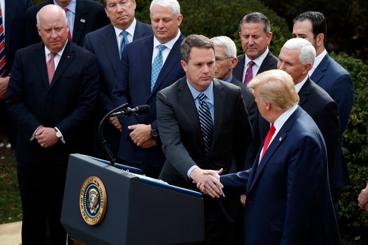 President Donald Trump shakes hands with Doug McMillon, president and CEO of Walmart Inc., during a news conference about the coronavirus on Friday.