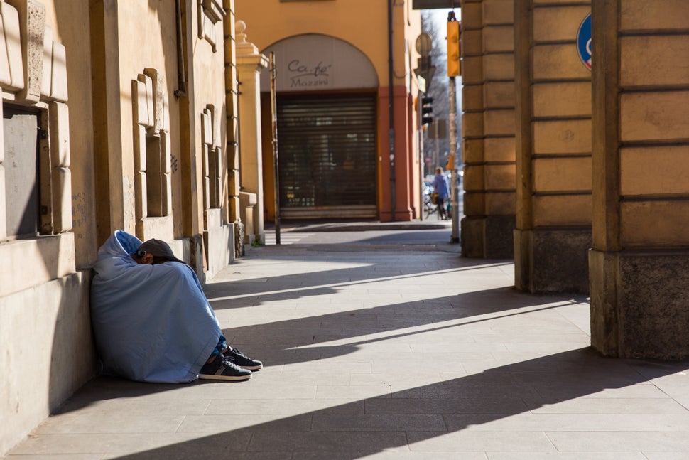 A homeless person sleeping under porches in Bologna during Italy's quarantine.