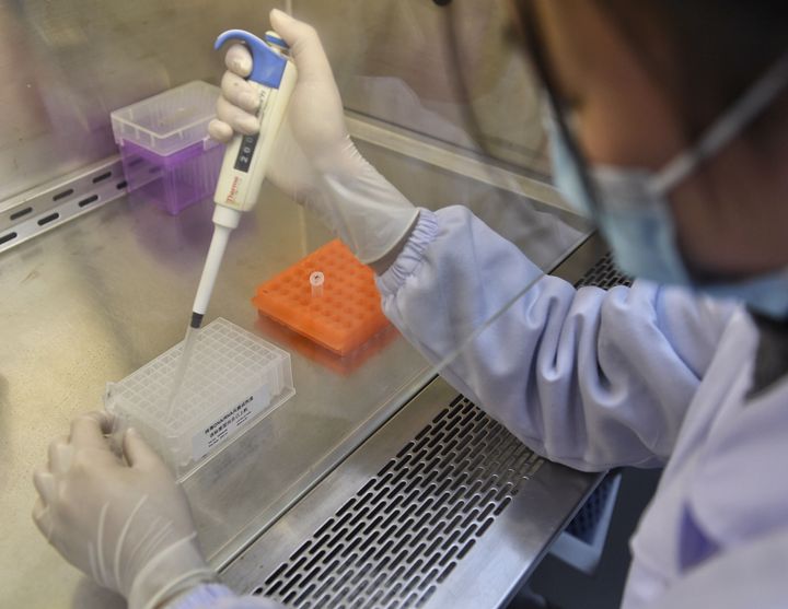A staff member checks the quality of nucleic acid extraction kits for coronavirus tesing at Chengdu Bio-Base Technologies Co., Ltd. in Chengdu, China.