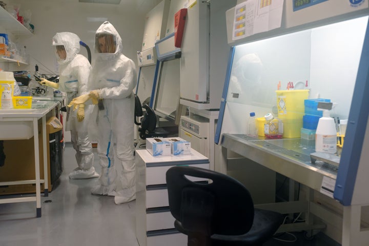 A virologist and a researcher working in a high-level biosafety security laboratory research COVID-19 at the Pasteur Institute of Lille in France on Feb. 20, 2020.