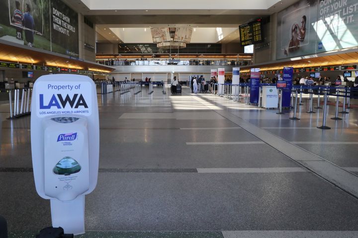 A hand sanitiser dispenser is seen at the empty international terminal at LAX airport in Los Angeles. 