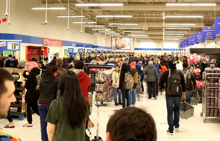 Crowds gather to buy groceries at Real Canadian Superstore in Vancouver on Monday. 