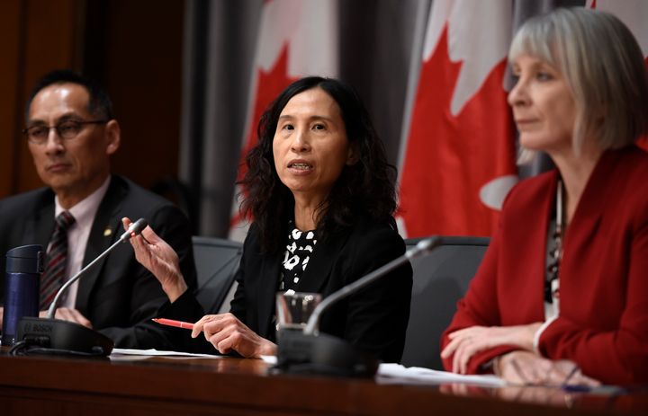 Chief Public Health Officer Dr. Theresa Tam, centre, speaks as Minister of Health Patty Hadju, right, and Deputy Chief Public Health Officer Dr. Howard Njoo, left, listen during a press conference on Parliament Hill in Ottawa on March 19, 2020.