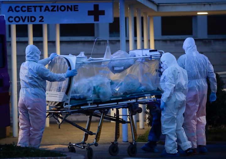 A patient in a biocontainment unit is carried on a stretcher at the Columbus Covid 2 Hospital in Rome on Monday.