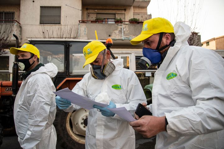 Three volunteers during the briefing of a road disinfection initiative on Thursday in Italy.