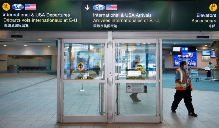 A airport worker is pictured at Vancouver International Airport in Richmond, B.C. on March 18, 2020. 