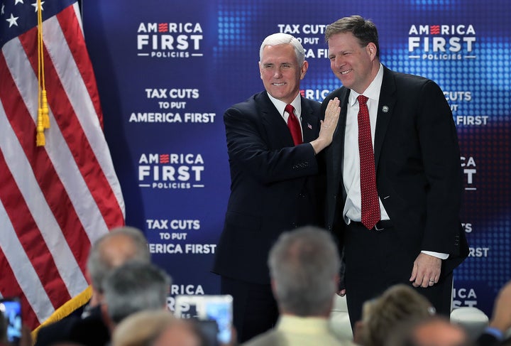 New Hampshire Gov. Christopher Sununu (R), pictured here with Vice President Mike Pence, keeps referring to the coronavirus as "the flu."