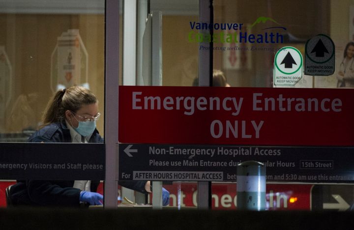 A hospital worker at the entrance of the emergency department at a Vancouver hospital on March 18, 2020. 