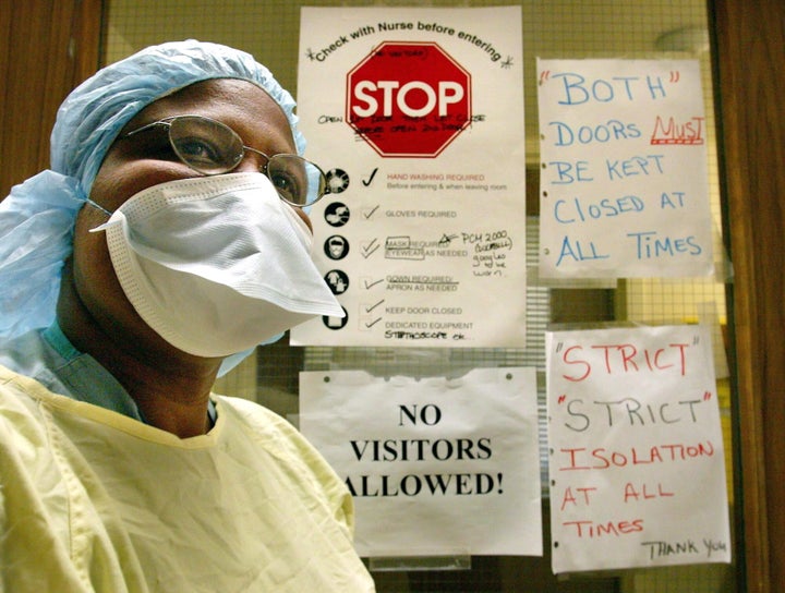 A nurse wears the protective clothing used when treating patients with SARS in Toronto on March 17, 2003. 