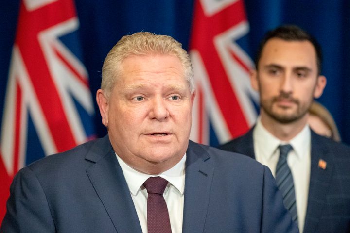 Ontario Premier Doug Ford speaks at a news conference with Education Minister Stephen Lecce listens at Queen's Park in Toronto on March 20, 2020.