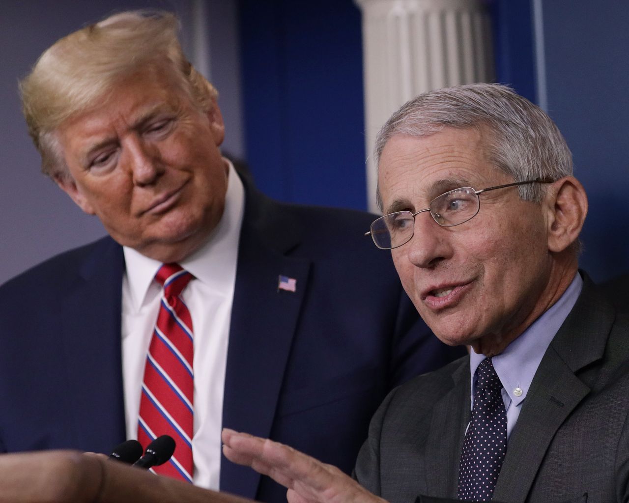 Donald Trump looks on as Dr Anthony Fauci, director of the National Institute of Allergy and Infectious Diseases, speaks during a press conference.