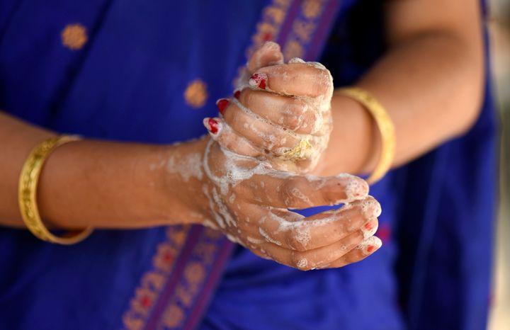 A woman washing her hands as she is protecting herself from Coronavirus, in a village at Barpeta district of Assam in India on Friday, 20 March 2020. (Photo by David Talukdar/NurPhoto via Getty Images)