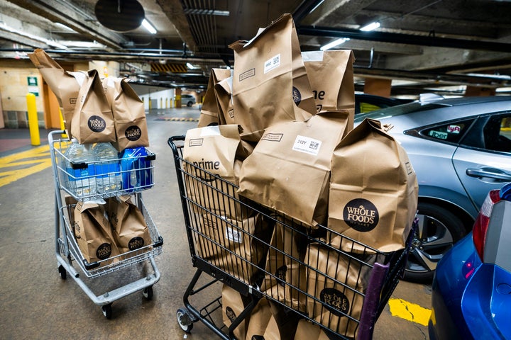 Online grocery orders await delivery at a Whole Foods in Washington, DC. More people are turning to delivery services as the coronavirus outbreak continues.