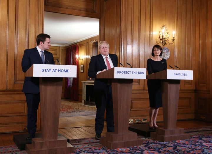 Boris Johnson is joined by Housing, Communities and Local Government Secretary Robert Jenrick, left, and Deputy Chief Medical Officer Jenny Harries.
