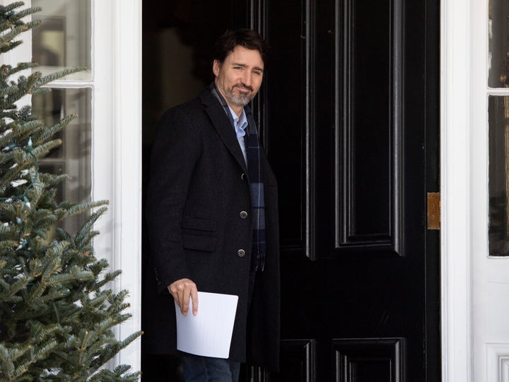 Prime Minister Justin Trudeau walks out the front door of his residence at Rideau Cottage to speak at a press conference about COVID-19 in Ottawa, on Sunday.