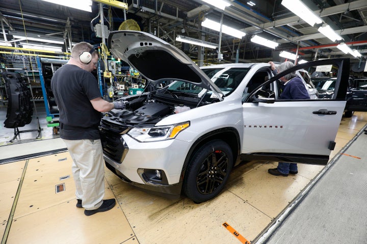 Vehicles go through the assembly line at a General Motors plant in Lansing, Michigan, in February.