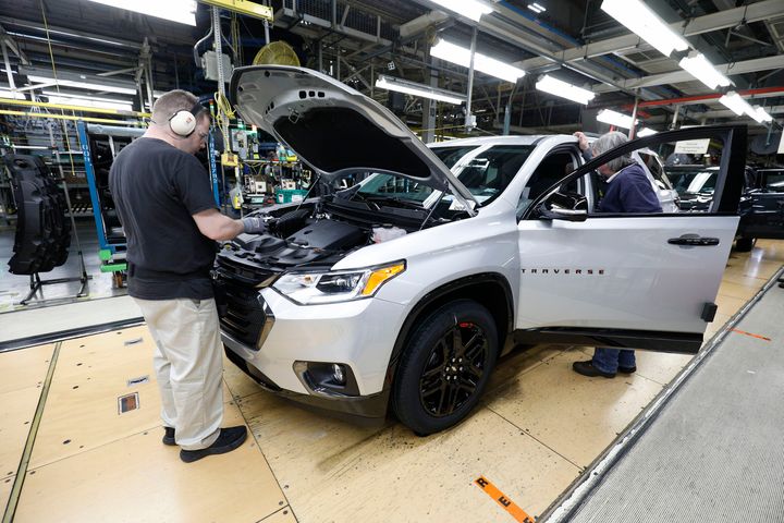 Vehicles go through the assembly line at a General Motors plant in Lansing, Michigan, in February. 