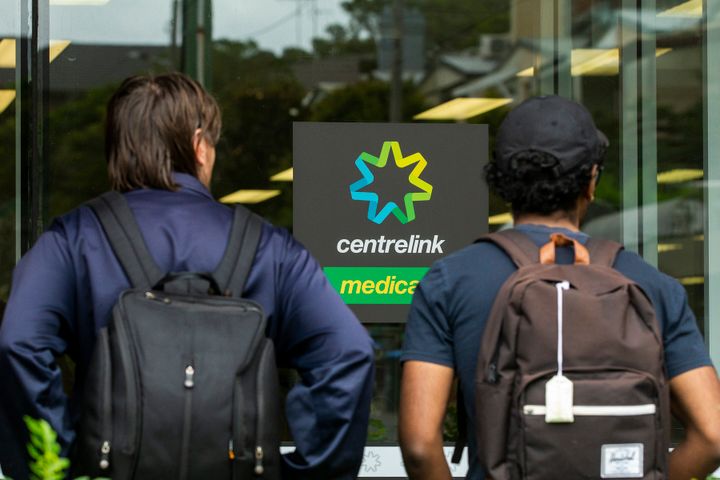 SYDNEY, AUSTRALIA - MARCH 23: People are seen lining up at Centrelink in Bondi Junction on March 23, 2020 in Sydney, Australia. From midday Monday, venues such as bars, clubs, nightclubs, cinemas, gyms and restaurants, along with anywhere people remain static would be closed. Schools remain open but parents have the option to keep children at home if they wish while Victoria is bringing forward school holidays from Tuesday. There are now 1353 confirmed cases of COVID-19 in Australia and the death toll now stands at seven. (Photo by Jenny Evans/Getty Images)