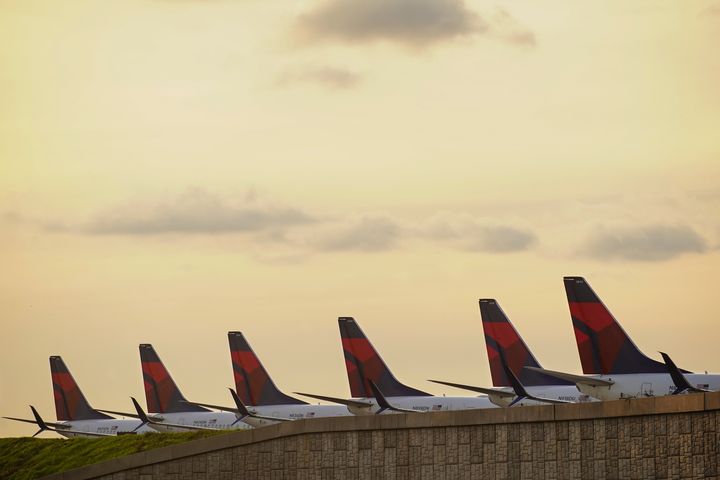 Delta Air Lines planes lined up on a runway at Atlanta Hartsfield-Jackson International Airport in Atlanta, Georgia, on March 21, 2020. They are parked due to flight reductions made to slow the spread of coronavirus disease.