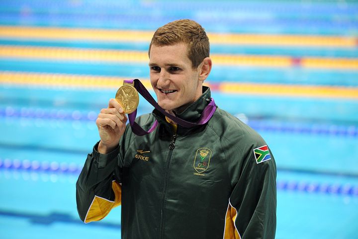 South Africa's Cameron van der Burgh shows off his gold medal after winning the 100 meter breaststroke final.
