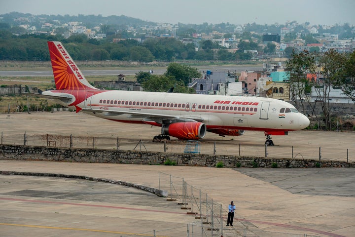 A security personnel stands guard near an Air India Airbus A-320 displayed at Begumpet Airport in Hyderabad on March 14, 2020. (Photo by NOAH SEELAM / AFP) (Photo by NOAH SEELAM/AFP via Getty Images)