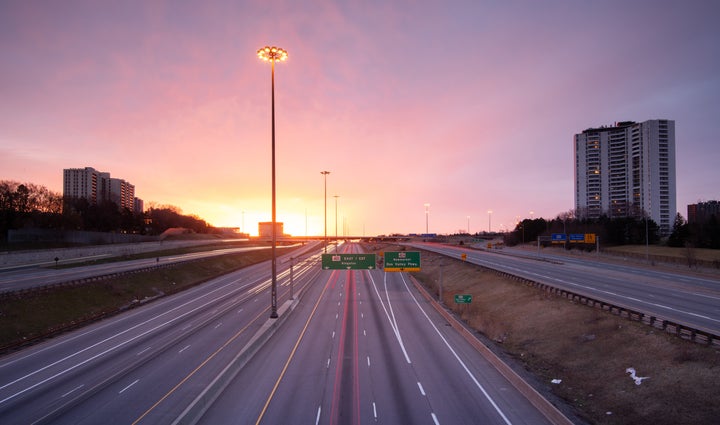 In this stock photo, an empty Highway 401 is seen at dusk in Toronto.