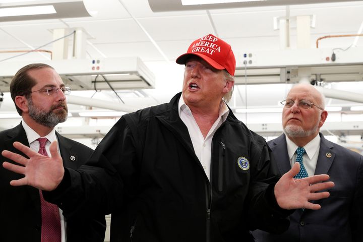 President Donald Trump delivers remarks beside HHS Secretary Alex Azar and Centers for Disease Control and Prevention Director Dr. Robert Redfield during a tour of the CDC following a COVID-19 coronavirus briefing in Atlanta, Georgia, March 6, 2020.