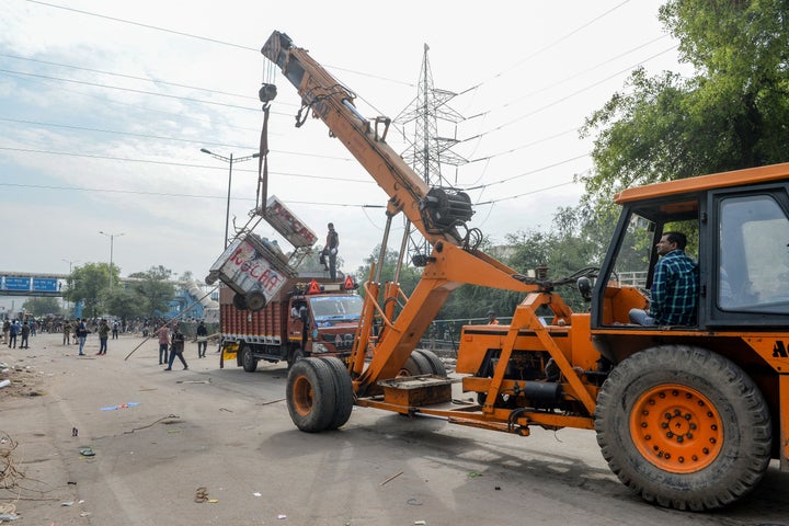 A crane is used to clean the streets in Shaheen Bagh area after protesters were removed on March 24, 2020.