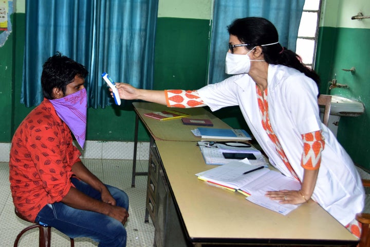 NAGAON,INDIA-MARCH 22,2020: A Doctor use thermal screening devices on youth who return from Kerela state in the wake of deadly coronavirus at Civil Hospital in Nagaon district of Assam,India - PHOTOGRAPH BY Anuwar Ali Hazarika / Barcroft Studios / Future Publishing (Photo credit should read Anuwar Ali Hazarika/Barcroft Media via Getty Images)