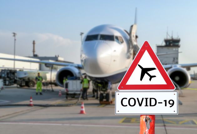 Airplane at the airport warning sign coronavirus