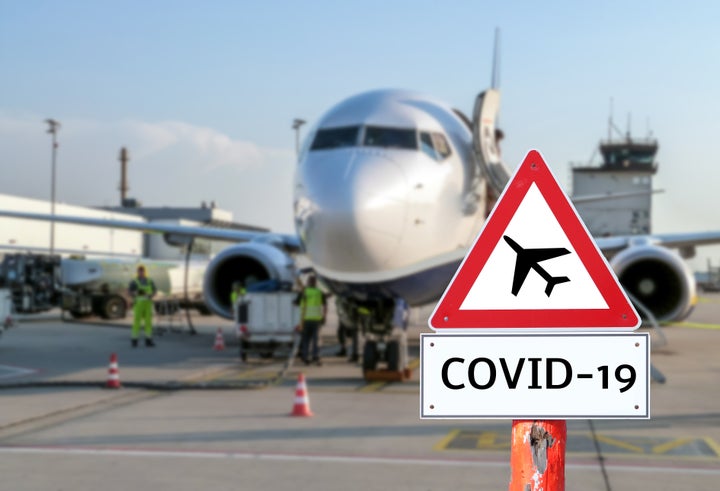 Airplane at the airport warning sign coronavirus