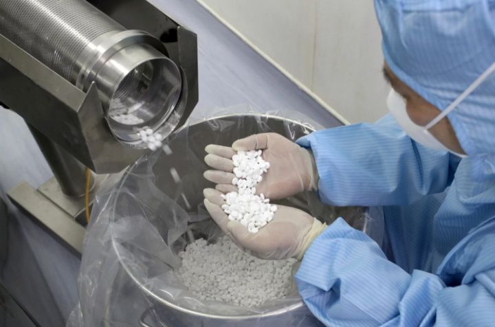 An employee at a pharmaceutical company in China’s Jiangsu province checks the production of chloroquine phosphate