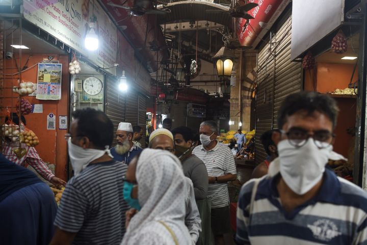 People shop in a Mumbai market on Tuesday, ahead of Modi's speech.