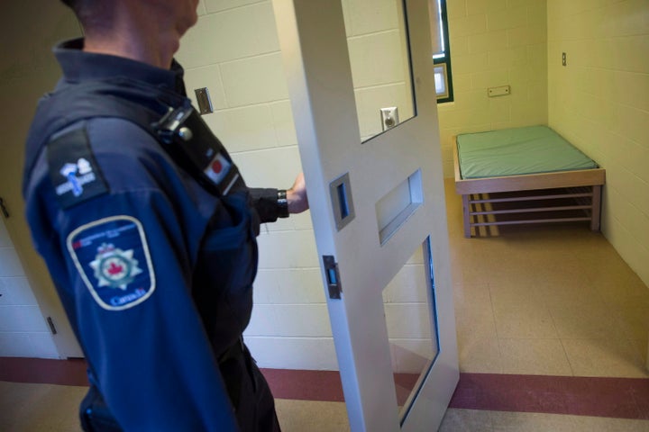 A correctional officer opens the door to a cell in the segregation unit at the Fraser Valley Institution for Women in Abbotsford, B.C. on Oct. 26, 2017.
