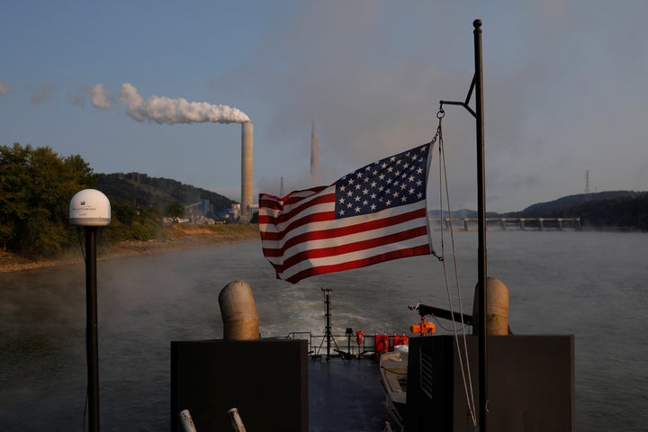 A boat passes the W. H. Sammis Power Plant, a coal-fired power plant owned by FirstEnergy, along the Ohio River in Stratton, Ohio.