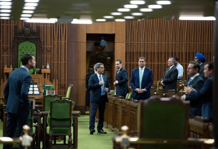 Conservative MPs, including leader Andrew Scheer, wait for the speaker's parade to arrive, as a limited number of MPs return to the house to discuss measures to respond to the COVID-19 outbreak, in Ottawa, on March 24, 2020. 