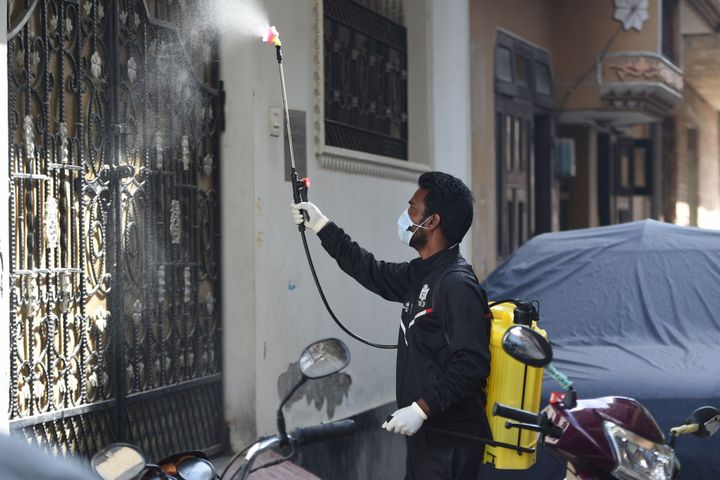 A worker sanitises a residential colony during the first day of a 21-day government-imposed nationwide lockdown as a preventive measure against the COVID-19 coronavirus in Faridabad in the state of Haryana on March 25, 2020.