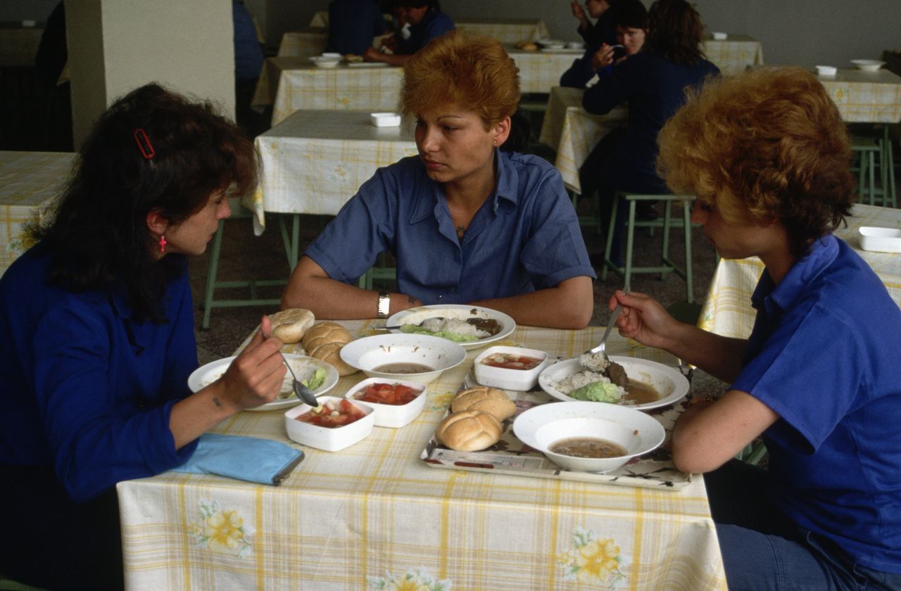 Women prisoners eating a prison canteen