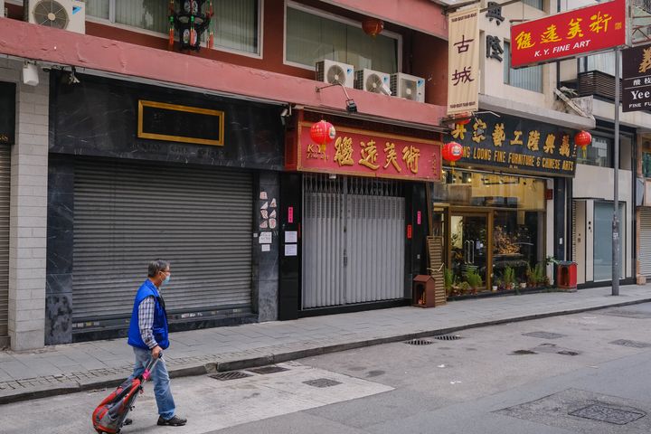 HONG KONG, CHINA - MARCH 26: A man walks past some empty stores during a coronavirus (COVID-19) outbreak on March 26, 2020 in Hong Kong, China. Latest statistics showed Hong Kong tourist arrivals plunge more than 96 per cent.The whole month's visitor arrivals only account for a day's total in the first half of last year. The record-low figure was far worse than when the city came under the grip of SARS in 2003. (Photo by Billy H.C. Kwok/Getty Images)