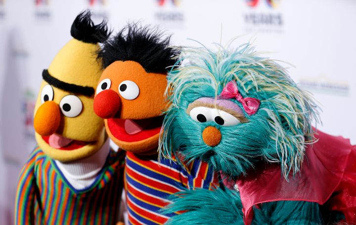 Bert, Ernie, and Rosalita of "Sesame Street" pose for a photo.