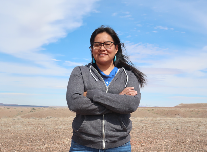 Shanna Yazzie stands in the desert near her home.