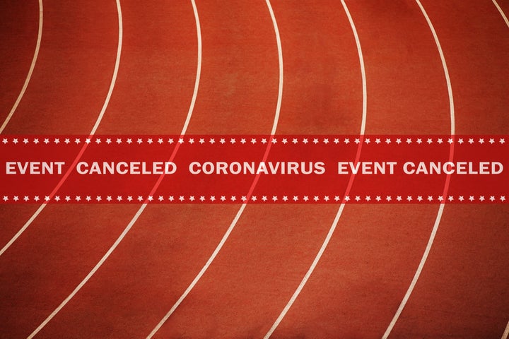 warning tape event canceled coronavirus in background running athletics red track